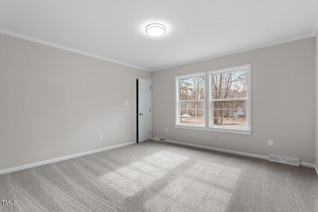 carpeted empty room featuring visible vents, baseboards, and ornamental molding