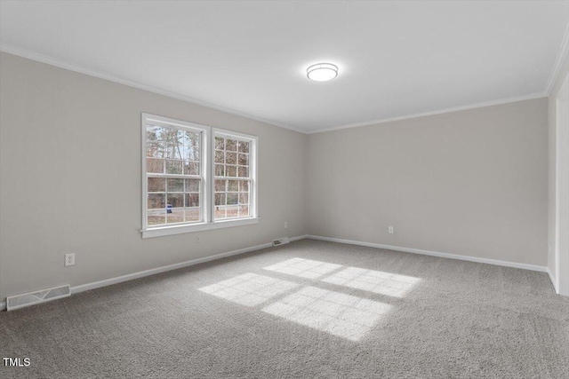 empty room with ornamental molding, baseboards, carpet, and visible vents