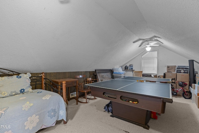 game room with a textured ceiling, carpet floors, lofted ceiling, and ceiling fan