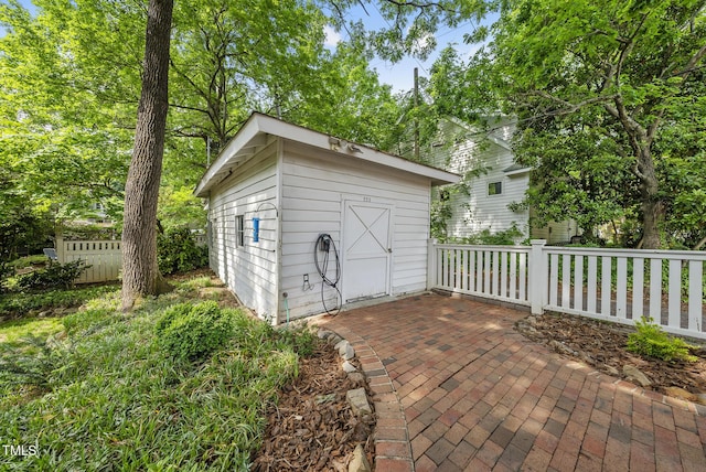 view of shed featuring fence