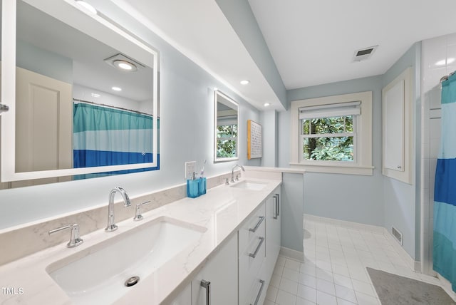 bathroom featuring baseboards, tile patterned floors, visible vents, and a sink