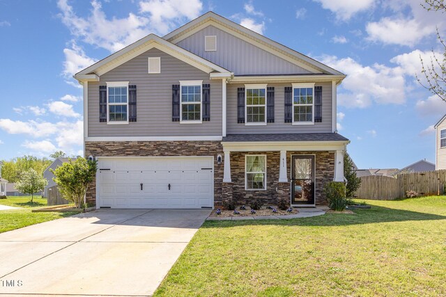 craftsman house with an attached garage, stone siding, fence, a front lawn, and driveway