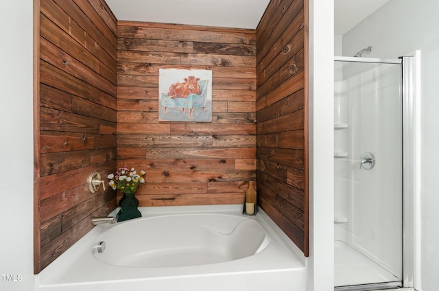 full bath with wooden walls, a garden tub, and a stall shower