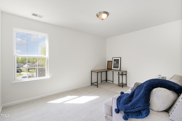 living area featuring visible vents, baseboards, and carpet