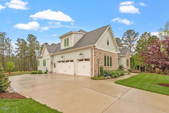 749 Golfers Vw, Pittsboro, NC 27312 - view of property exterior with a yard, driveway, and stone siding