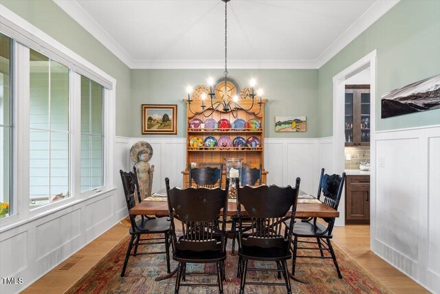 749 Golfers Vw, Pittsboro, NC 27312 - dining area with a decorative wall, visible vents, an inviting chandelier, and wood finished floors