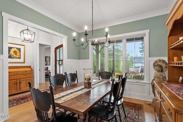749 Golfers Vw, Pittsboro, NC 27312 - dining room with a decorative wall, a wainscoted wall, a chandelier, and wood finished floors