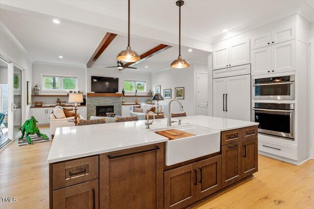 749 Golfers Vw, Pittsboro, NC 27312 - kitchen with a sink, a wealth of natural light, a ceiling fan, paneled built in refrigerator, and stainless steel double oven