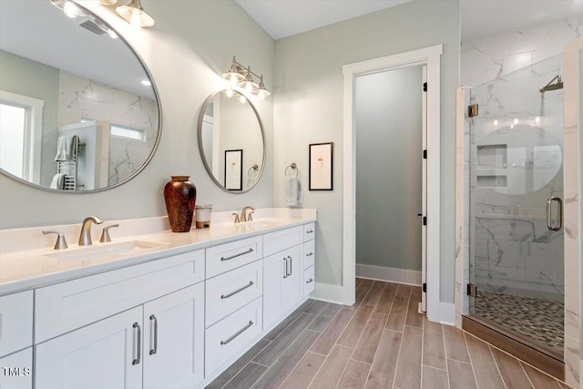 749 Golfers Vw, Pittsboro, NC 27312 - bathroom featuring a sink, baseboards, a marble finish shower, and wood finish floors