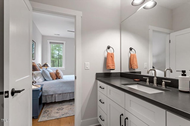 749 Golfers Vw, Pittsboro, NC 27312 - bathroom with wood finished floors, vanity, visible vents, and connected bathroom