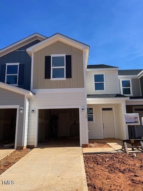 158 Parker Ln, Mebane, NC 27302 - view of front of property featuring board and batten siding, a garage, and driveway