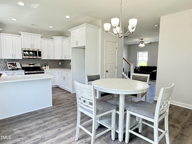 1387 Stoney Creek Church Rd, Goldsboro, NC 27534 - kitchen with stainless steel appliances, white cabinetry, ceiling fan with notable chandelier, and tasteful backsplash
