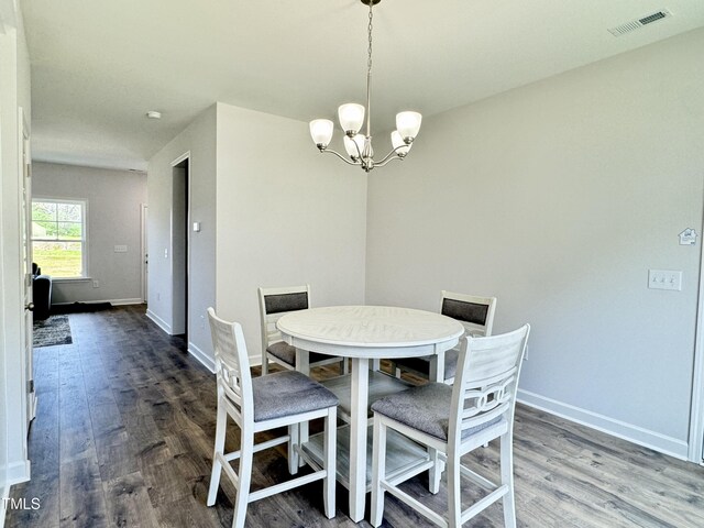 1387 Stoney Creek Church Rd, Goldsboro, NC 27534 - dining space with a chandelier, visible vents, wood finished floors, and baseboards