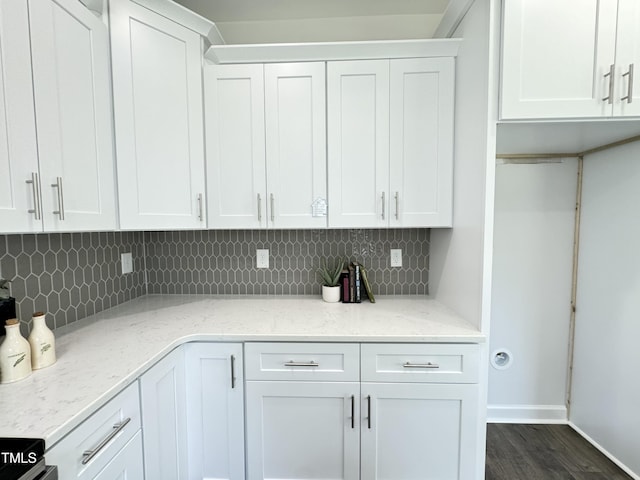 1387 Stoney Creek Church Rd, Goldsboro, NC 27534 - kitchen with dark wood finished floors, white cabinetry, tasteful backsplash, and light stone countertops