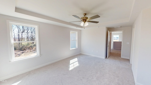1387 Stoney Creek Church Rd, Goldsboro, NC 27534 - empty room with baseboards, a raised ceiling, ceiling fan, and light colored carpet