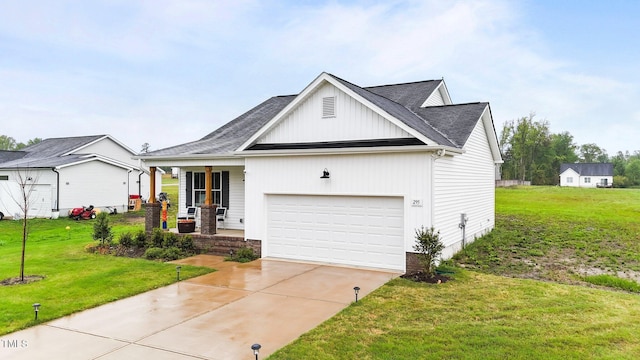 295 Springtooth Dr, Zebulon, NC 27597 - view of front of property featuring covered porch, roof with shingles, a front yard, an attached garage, and driveway