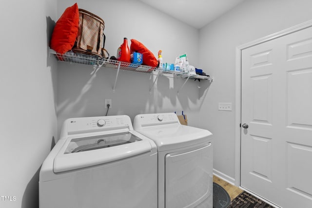 295 Springtooth Dr, Zebulon, NC 27597 - clothes washing area featuring independent washer and dryer, laundry area, baseboards, and light wood-style floors