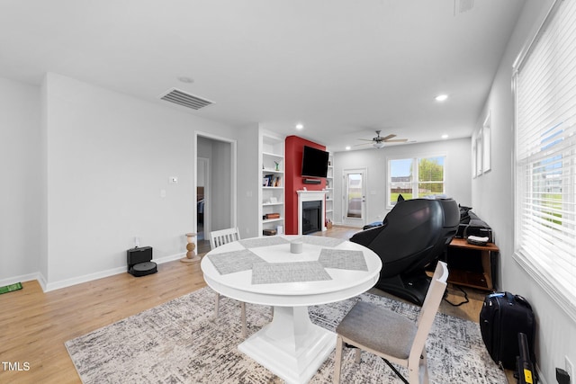 295 Springtooth Dr, Zebulon, NC 27597 - interior space featuring light wood-type flooring, recessed lighting, a fireplace, a ceiling fan, and visible vents