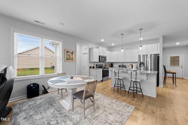 295 Springtooth Dr, Zebulon, NC 27597 - dining space featuring recessed lighting, light wood-style floors, baseboards, and visible vents