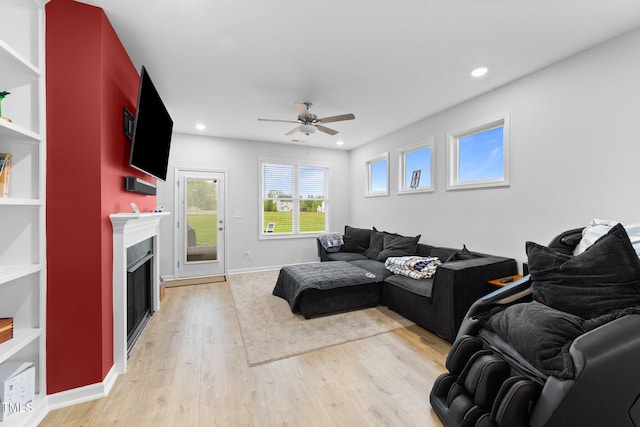 295 Springtooth Dr, Zebulon, NC 27597 - living room with light wood-style floors, a fireplace, a ceiling fan, and recessed lighting