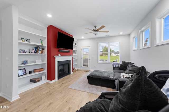 295 Springtooth Dr, Zebulon, NC 27597 - living area featuring baseboards, light wood-type flooring, a fireplace, recessed lighting, and a ceiling fan
