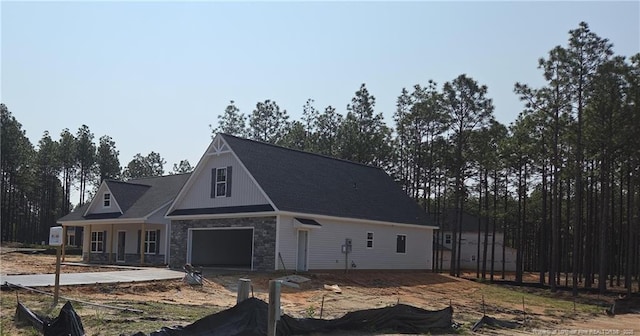 1105 Wolf Pine Ct, Fayetteville, NC 28311 - view of front of house with stone siding, concrete driveway, and a garage