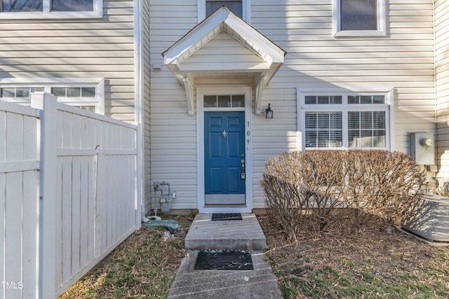 property entrance with fence and central AC