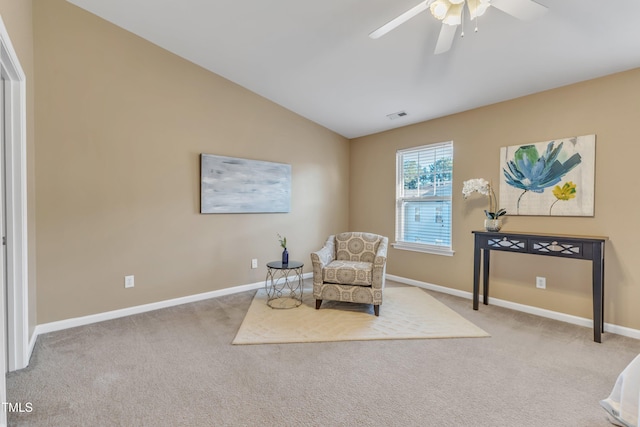 sitting room with ceiling fan, carpet, visible vents, vaulted ceiling, and baseboards