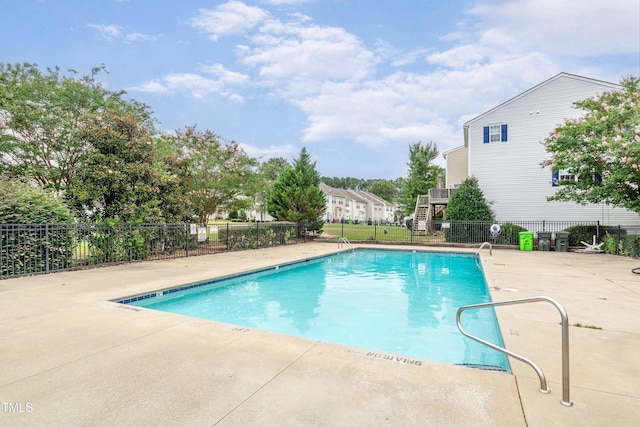 pool featuring fence and a patio