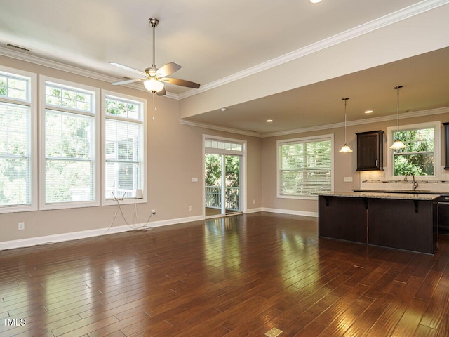 65 N Wilders Ridge Way, Clayton, NC 27527 - kitchen featuring open floor plan, a breakfast bar area, a ceiling fan, dark brown cabinetry, and plenty of natural light
