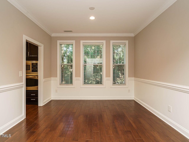 65 N Wilders Ridge Way, Clayton, NC 27527 - unfurnished room with dark wood-style floors, ornamental molding, and a wainscoted wall