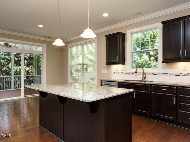 65 N Wilders Ridge Way, Clayton, NC 27527 - kitchen featuring a kitchen breakfast bar, dark wood-type flooring, a kitchen island, plenty of natural light, and ornamental molding
