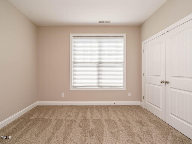 65 N Wilders Ridge Way, Clayton, NC 27527 - unfurnished bedroom featuring carpet, multiple windows, and a closet