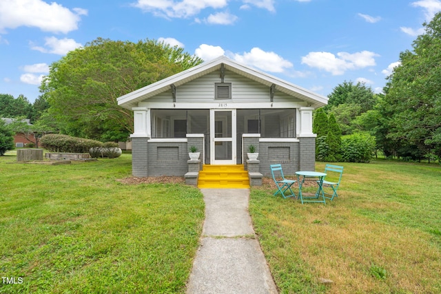 2815 Orange Grove Rd, Hillsborough, NC 27278 - view of front facade featuring a sunroom, brick siding, and a front lawn