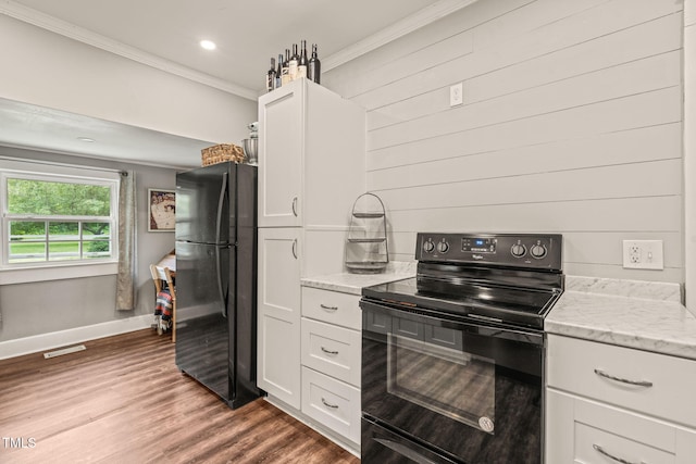 2815 Orange Grove Rd, Hillsborough, NC 27278 - kitchen featuring freestanding refrigerator, black range with electric stovetop, ornamental molding, white cabinetry, and baseboards