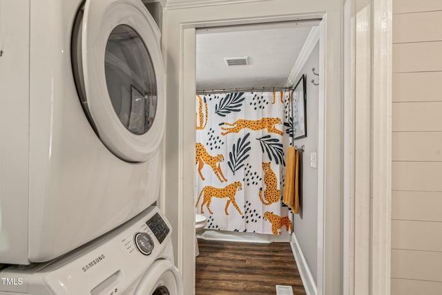 2815 Orange Grove Rd, Hillsborough, NC 27278 - laundry room featuring stacked washer and clothes dryer, wood finished floors, ornamental molding, and baseboards