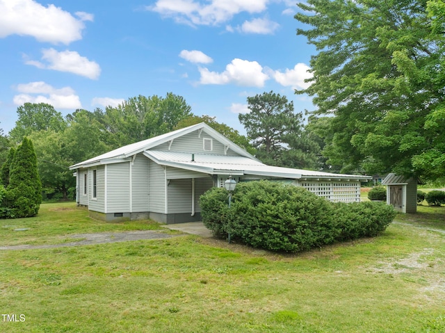 2815 Orange Grove Rd, Hillsborough, NC 27278 - view of property exterior featuring a yard, a carport, metal roof, and asphalt driveway