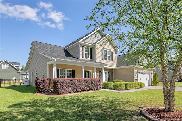 view of front of property with an attached garage, stone siding, fence, concrete driveway, and a front lawn