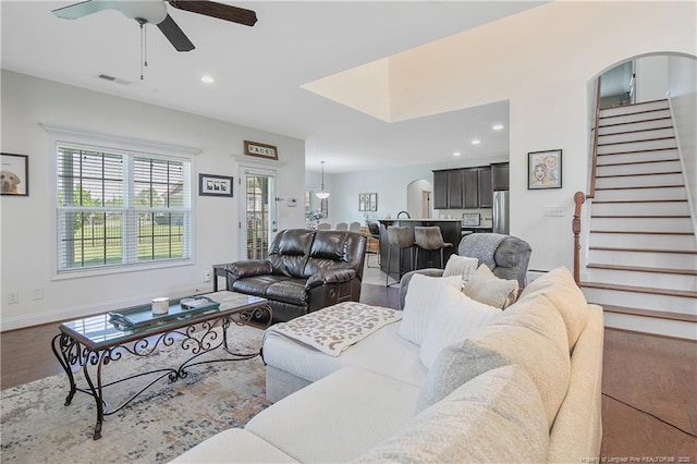 living area featuring a ceiling fan, visible vents, recessed lighting, wood finished floors, and stairs
