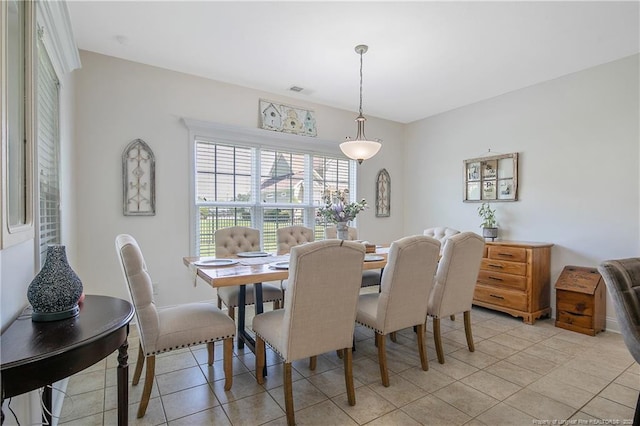 dining area featuring baseboards and light tile patterned flooring