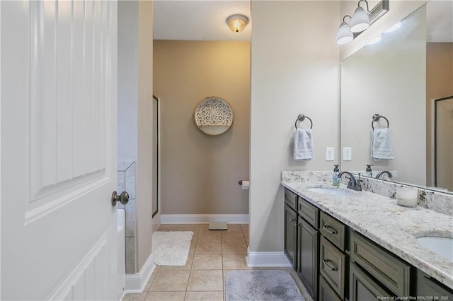 bathroom with a sink, double vanity, tile patterned flooring, and a shower with shower door