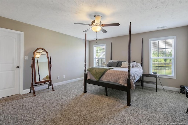 bedroom featuring visible vents, baseboards, carpet flooring, and a textured ceiling