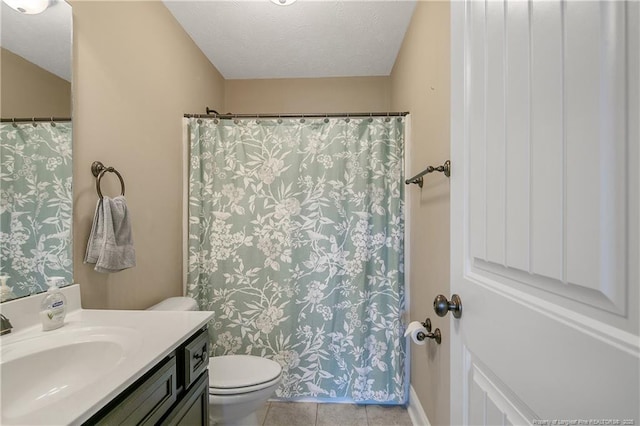 full bath with toilet, tile patterned floors, vanity, and a textured ceiling