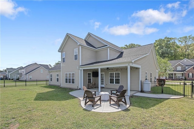 rear view of house with a patio area, a fenced backyard, a ceiling fan, and a lawn