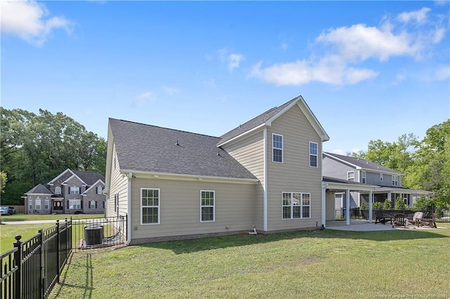 back of house with a patio, a lawn, central AC unit, a fenced backyard, and a shingled roof