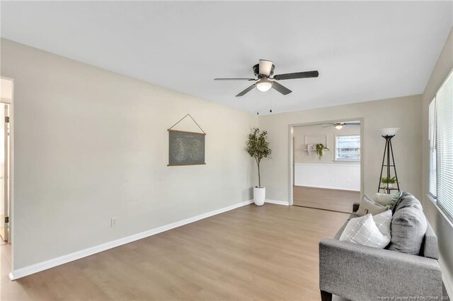 7517 Seaton Pl, Fayetteville, NC 28303 - unfurnished living room with light wood-type flooring, baseboards, and a ceiling fan