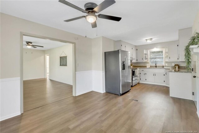 7517 Seaton Pl, Fayetteville, NC 28303 - kitchen featuring a sink, ceiling fan, light wood-style floors, white cabinetry, and stainless steel appliances