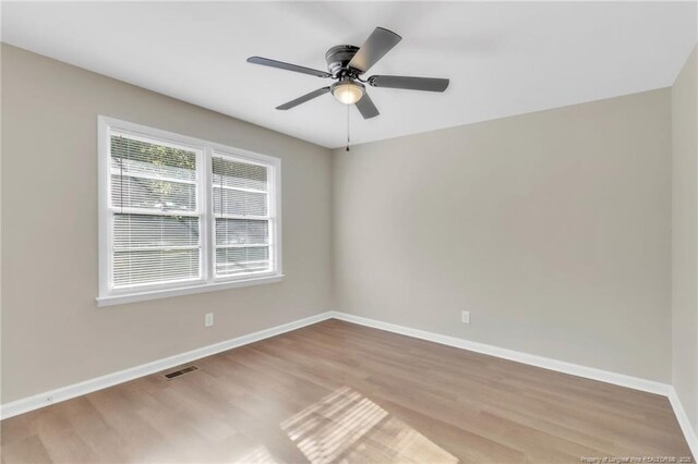 7517 Seaton Pl, Fayetteville, NC 28303 - spare room featuring wood finished floors, ceiling fan, baseboards, and visible vents