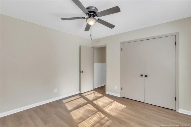 7517 Seaton Pl, Fayetteville, NC 28303 - unfurnished bedroom with a closet, baseboards, ceiling fan, and light wood-style floors