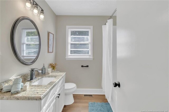 7517 Seaton Pl, Fayetteville, NC 28303 - bathroom featuring vanity, baseboards, toilet, visible vents, and wood finished floors